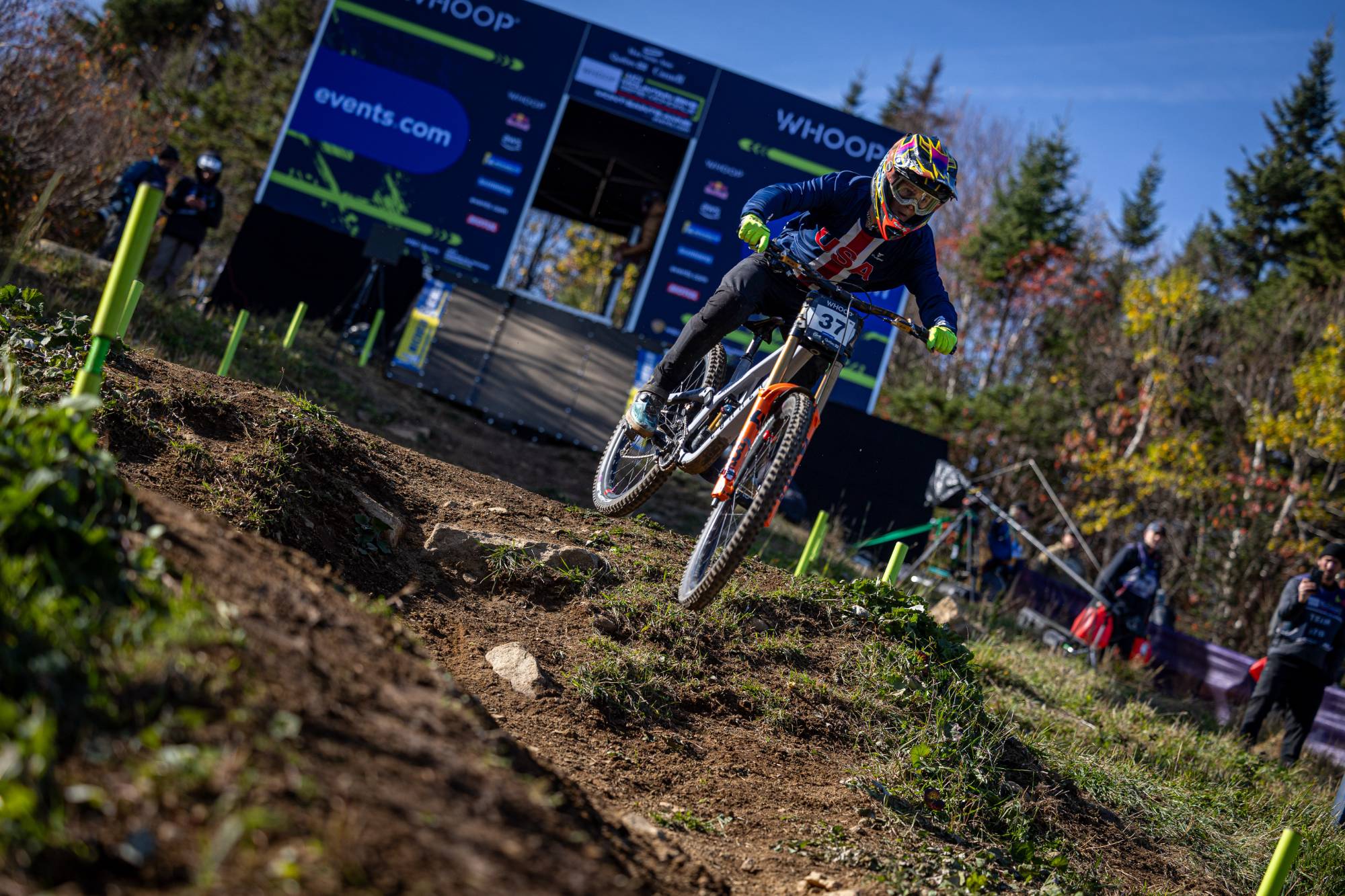 A young racer in USA kit racing downhill at a World Cup