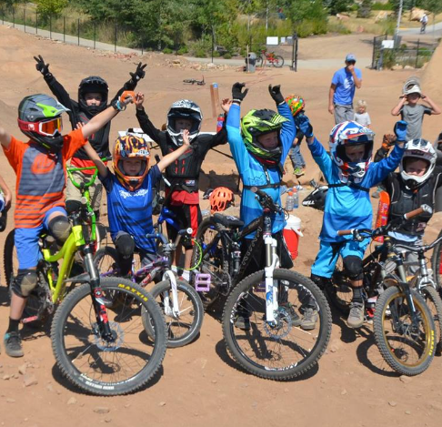 Young riders cheering with their bikes